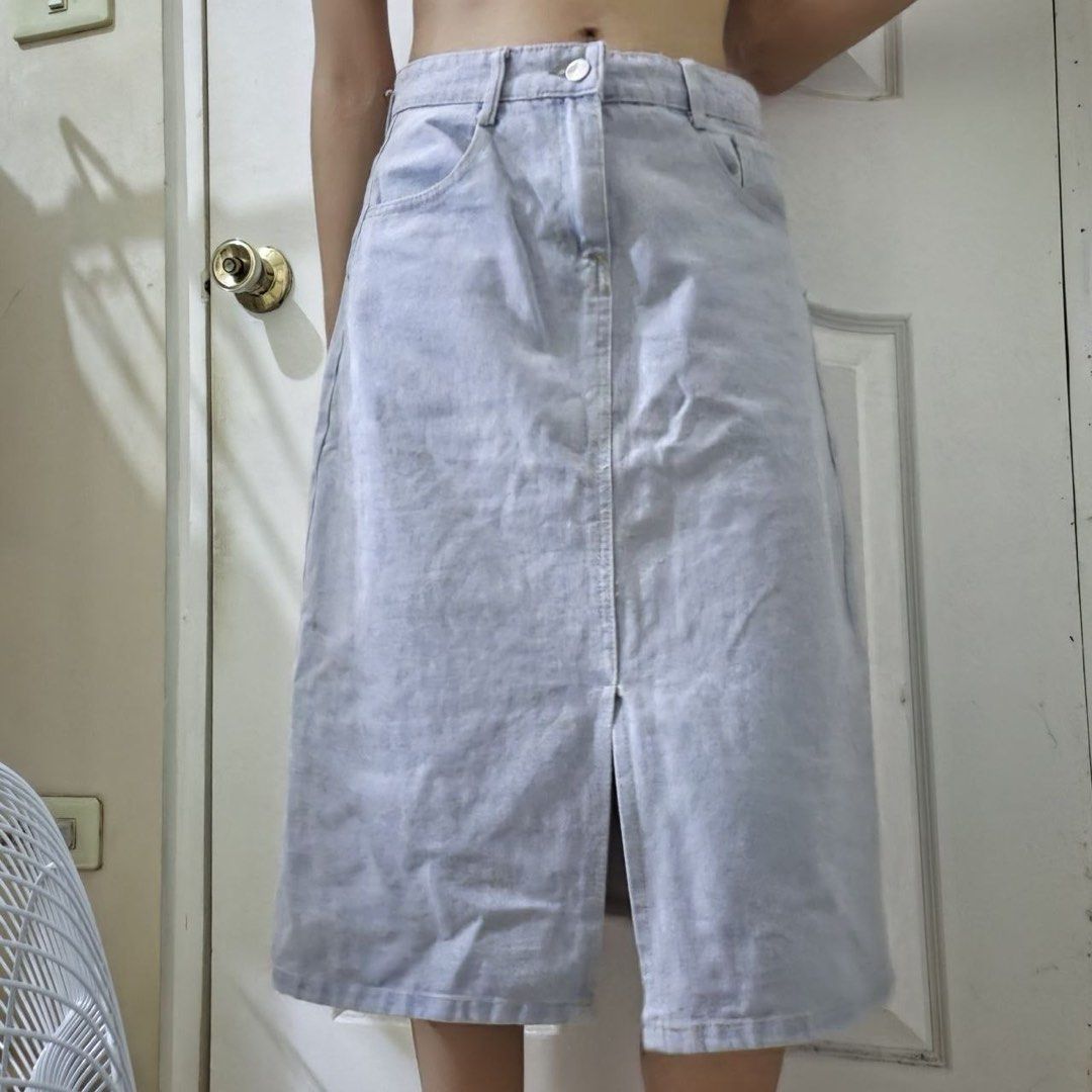 Light denim midi skirt with front slit (Category: Skirts) located in Marikina City. Submitted by preloved.mana (Listing ID 1471089004, Image 1). Description: - Light wash blue denim midi skirt with a trendy front slit - with button and zip fly with belt loops - MOP: gcash, maya - MOD: jnt, lalamove - LOC: marikina .