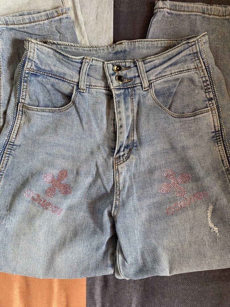 Light Wash Jeans Bundle (Category: Jeans) located in Manila. Submitted by heyheyruok (Listing ID 1470963699, Image 2). Description: - Bundle includes: 2 pairs of light wash denim jeans - Pair 1: Sparkly rhinestone clover graphics, side rhinestones, button fly closure, and slight distressing - Pair 2: Comfortable elastic waistband, standard pockets, size Medium tag inside - Style: Easy to pair with casual tees or crop tops for everyday wear - Reas