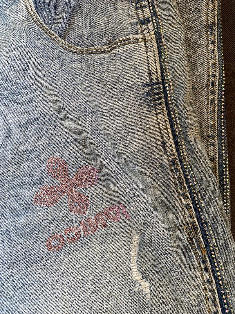 Light Wash Jeans Bundle (Category: Jeans) located in Manila. Submitted by heyheyruok (Listing ID 1470963699, Image 3). Description: - Bundle includes: 2 pairs of light wash denim jeans - Pair 1: Sparkly rhinestone clover graphics, side rhinestones, button fly closure, and slight distressing - Pair 2: Comfortable elastic waistband, standard pockets, size Medium tag inside - Style: Easy to pair with casual tees or crop tops for everyday wear - Reas