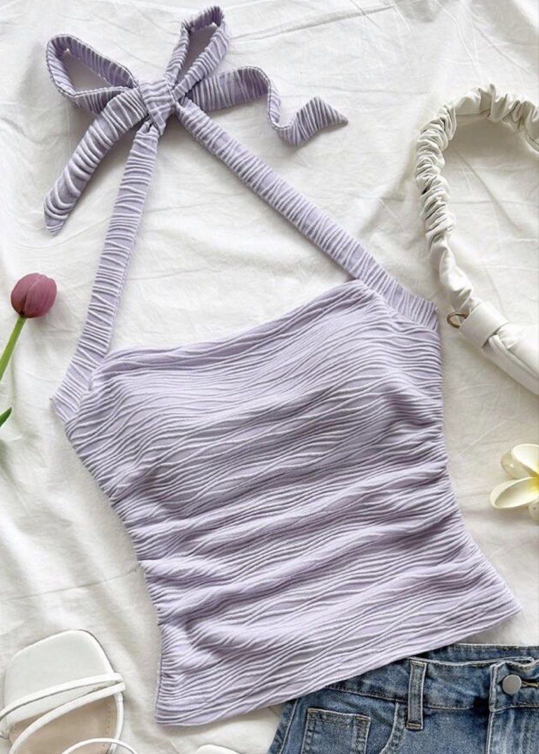 Lilac Halter Neck Textured Top with Tie Back (Category: Sleeveless) located in Manila. Submitted by coffeeislyf (Listing ID 1470990409, Image 1). Description: - Color: Lilac - Style: Halter neck with self-tie back straps - Fit: Fitted silhouette, stretchy fabric - Details: All-over crinkled texture - Condition: Clean and ready to wear - Perfect for: Casual day outs or pairing with high-waisted denim shorts.