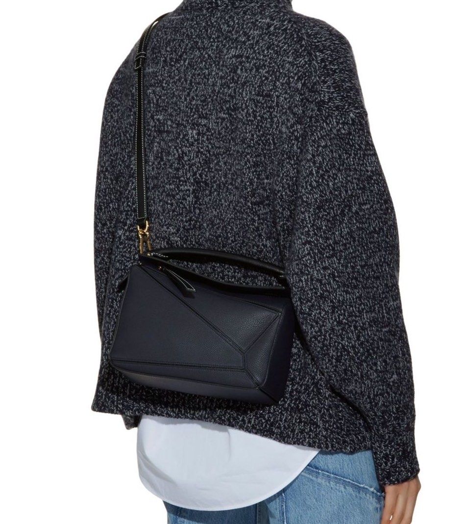 Loewe Puzzle Bag Black Leather (Category: Luxury Bags & Wallets) located in Manila. Submitted by caramelbliss (Listing ID 1471040707, Image 1). Description: - Loewe Puzzle bag in black grained leather - Iconic geometric panel design with chic contrast white stitching - Premium gold-tone hardware and embossed Anagram logo - Comes with an adjustable and detachable shoulder strap - Maintains a clean, structured shape and holds its form well - Condit