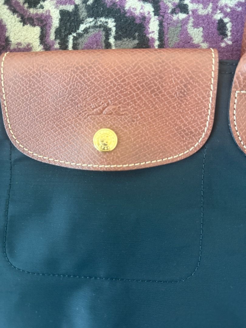 Longchamp Paris Nylon Tote Bag (Category: Luxury Bags & Wallets) located in Quezon City. Submitted by articolipreamati (Listing ID 1470997715, Image 2). Description: - Brand: Longchamp Paris - Style: Classic everyday tote / shoulder bag - Color: Black with brown leather handles and flap closure - Hardware: Gold-tone hardware with signature horse logo zipper pull - Interior: Spacious main compartment - Authenticity details: Inside tag includes mod