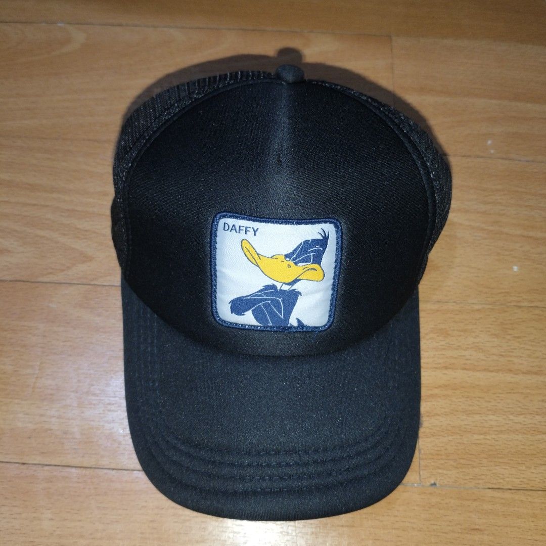 Looney Tunes Daffy Duck Trucker Cap (Category: Caps & Hats) located in Manila. Submitted by usedtobeyours26 (Listing ID 1471073946, Image 1). Description: - Daffy Duck front patch graphic - Breathable black mesh back panels - Adjustable plastic snapback closure for a customized fit - Eye-catching yellow and black side embroidery - Classic curved brim and structured front foam panel - Condition: Excellent .