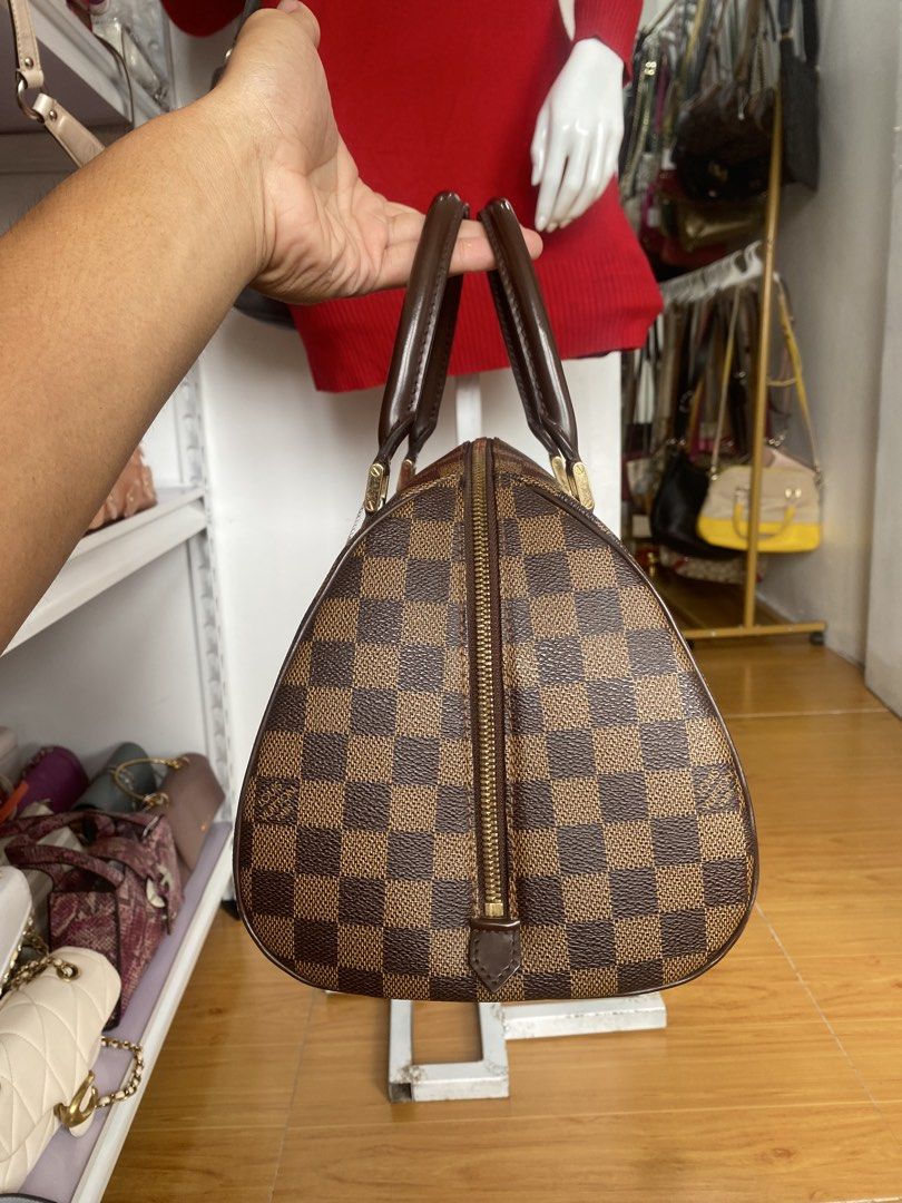 Louis Vuitton Damier Ebene Handbag (Category: Luxury Bags & Wallets) located in San Fernando. Submitted by thrifteezy6 (Listing ID 1470961057, Image 2). Description: - Iconic Brown Damier Ebene checkered canvas - Premium dark brown leather top handles - Elegant gold-tone hardware with LV-stamped zipper pullers - Secure full zip-around closure - Structured silhouette with a flat base for easy storage - 100% authentic and well-maintained - Message 