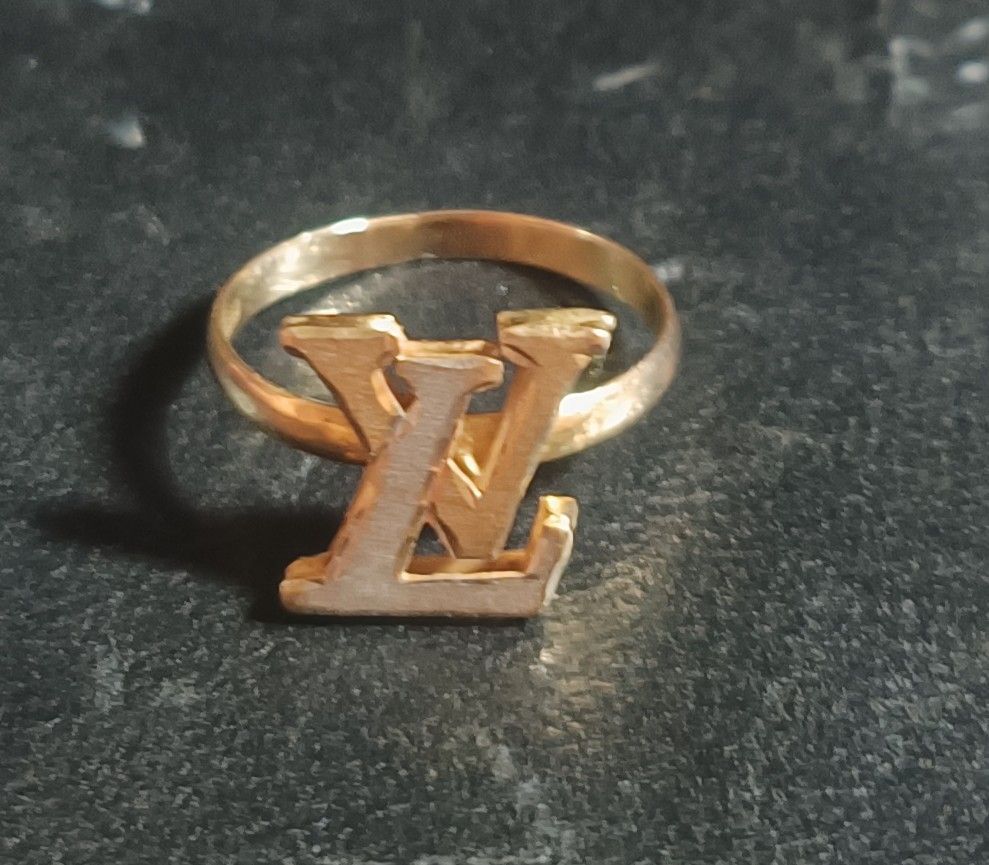 Louis Vuitton LV Logo 18k Gold Ring Pawnable (Category: Rings) located in Cebu City. Submitted by elen30abalo (Listing ID 1470954486, Image 1). Description: - money back guaranteed - Gold ring with iconic LV initials - Thin, comfortable band design - Perfect statement accessory for daily wear or going out - Minimalist look with classic branding - No box included.
