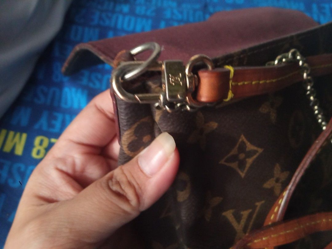 Louis Vuitton Monogram Flap Crossbody Bag (Category: Luxury Bags & Wallets) located in Manila. Submitted by littlelove25 (Listing ID 1471030989, Image 3). Description: - Brand: Louis Vuitton - Style: Monogram canvas flap bag with gold-tone hardware plate - Inclusions: Attached leather shoulder strap and chain detail - Condition: Noticeable wear and fraying near the side attachment loops, with heavy scratches on the front metal plate - Perfect for