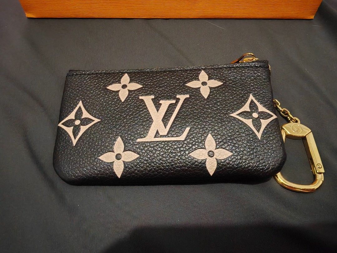 Louis Vuitton Monogram Key Pouch Black Beige (Category: Luxury Bags & Wallets) located in Quezon City. Submitted by sashasarisarishoppe (Listing ID 1470985126, Image 2). Description: - Brand: Louis Vuitton - Material: Black Monogram Empreinte leather with cream embossed motifs - Hardware: Gold-tone - Features: Zip closure, attached chain, and hook - Origin: Made in France stamp inside - Inclusions: Original box and ribbon included - With Receipt,