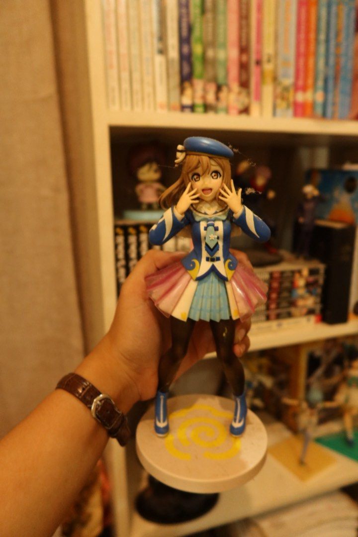Love Live! Anime Figure Lot (Category: Figurines & Statues) located in Arayat. Submitted by sunnydienna (Listing ID 1471060289, Image 3). Description: Bundle of multiple Love Live! character figures. Includes Kanan Matsuura with her green triangular base. Various poses and outfits shown across the shelf display. Dust present on some surfaces from shelf storage. Great addition for any anime collector looking to expand their display setup. with 2 f