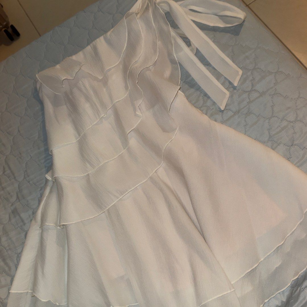 Lovito One-Shoulder Ruffle Dress (Category: Dresses) located in Manila. Submitted by shopmakii (Listing ID 1471093760, Image 1). Description: - Brand: Lovito - Style: One-shoulder asymmetric dress with layered ruffles and tie-shoulder strap - Color: Solid White - Size: XS (EU 32, US 2) - Features: Flowy tiered skirt hemline, lightweight fabric, and inner lining - Perfect for: Casual outings, dates, and summer events.