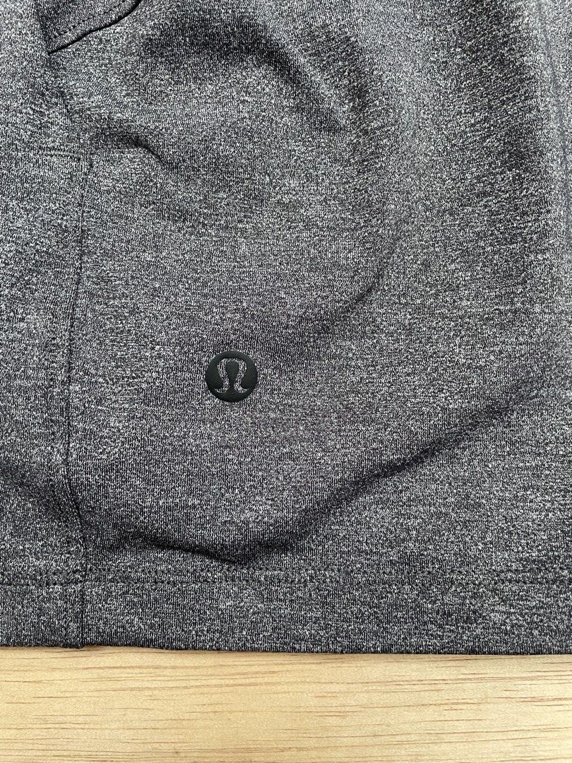Lululemon Athletic Shorts Size 4 Grey (Category: Shorts) located in Cebu City. Submitted by pinoclifford (Listing ID 1471041244, Image 2). Description: - Brand: Lululemon - Color: Heathered Grey - Size: 4 - Material: Nylon, polyester, and lycra elastane blend - Features: Elastic waistband, adjustable black drawstring with branded metal tips - Details: Small reflective logo on the lower left hem and multiple convenient pockets.