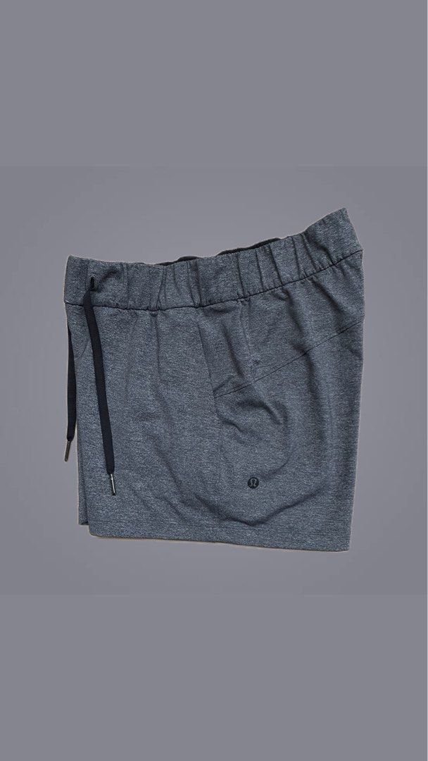 Lululemon Athletic Shorts Size 4 Grey (Category: Shorts) located in Cebu City. Submitted by pinoclifford (Listing ID 1471041244, Image 1). Description: - Brand: Lululemon - Color: Heathered Grey - Size: 4 - Material: Nylon, polyester, and lycra elastane blend - Features: Elastic waistband, adjustable black drawstring with branded metal tips - Details: Small reflective logo on the lower left hem and multiple convenient pockets.
