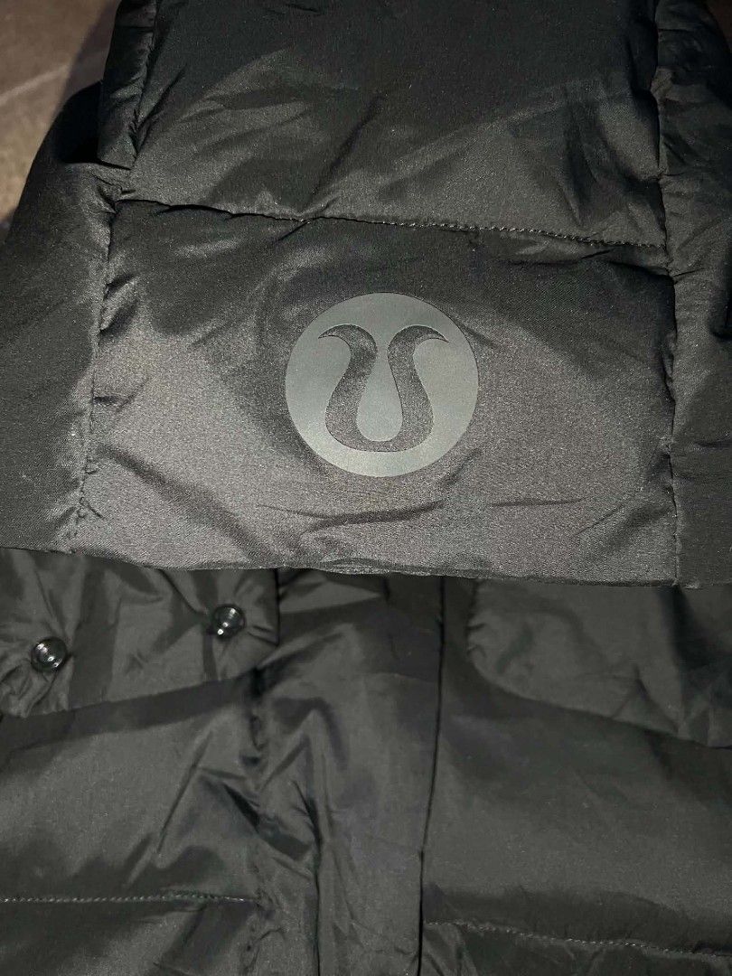 Lululemon Black Down Puffer Jacket Size 6 (Category: Coats, Jackets and Outerwear) located in Urdaneta. Submitted by jayceegarage (Listing ID 1470881319, Image 3). Description: Lululemon down puffer jacket in classic black. Size 6, 175/84A. Zip up front with snap buttons and detachable hood featuring the iconic logo on the back. Filled with 80% white goose down and 20% white goose feathers. Super warm for cold weather..