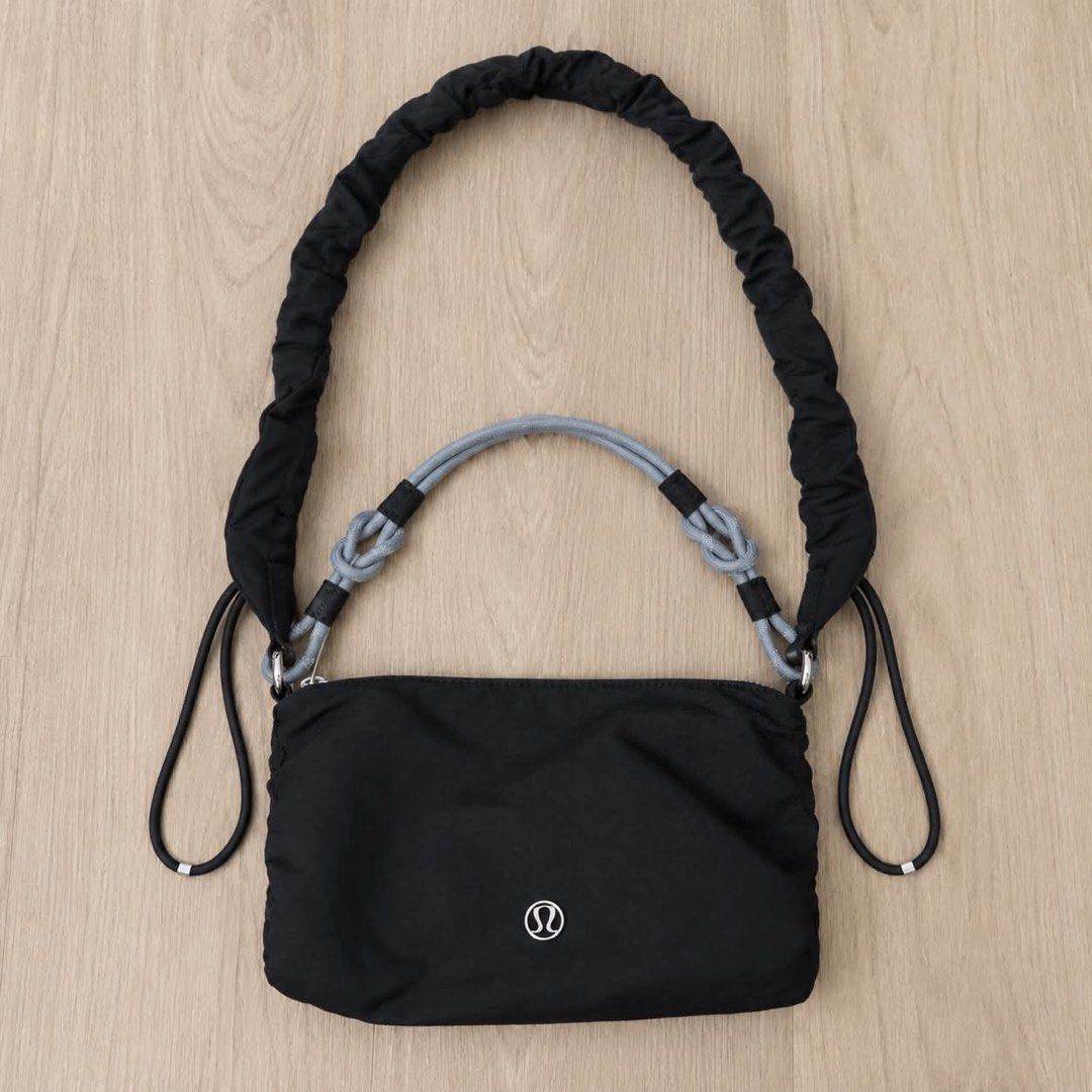 Lululemon Black Shoulder Bag (Category: Shoulder Bags) located in Manila. Submitted by mixi_lexi (Listing ID 1471050127, Image 1). Description: - Brand: Lululemon - Style: Shoulder bag / Crossbody - Color: Black with silver-tone hardware - Material: Durable nylon - Dimensions: 13 x 21 cm - Straps included: Gathered black strap and an extra grey knotted rope handle - Condition: Clean interior lining with tag intact - Perfect for daily errands, cas