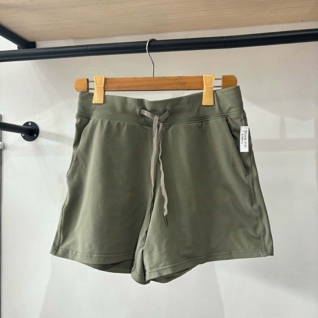 Lululemon Olive Green Athletic Shorts (Category: Shorts) located in Bambang. Submitted by heats777 (Listing ID 1471010953, Image 1). Description: - Brand: Lululemon - Color: Olive green - Fabric: Smooth, stretchy, high-performance material - Waistband: Elastic with adjustable drawstring closure - Features: Convenient front pockets and back yoke seam - Detail: Reflective logo heat-pressed on the back leg hem - Condition: Excellent, well-maintained