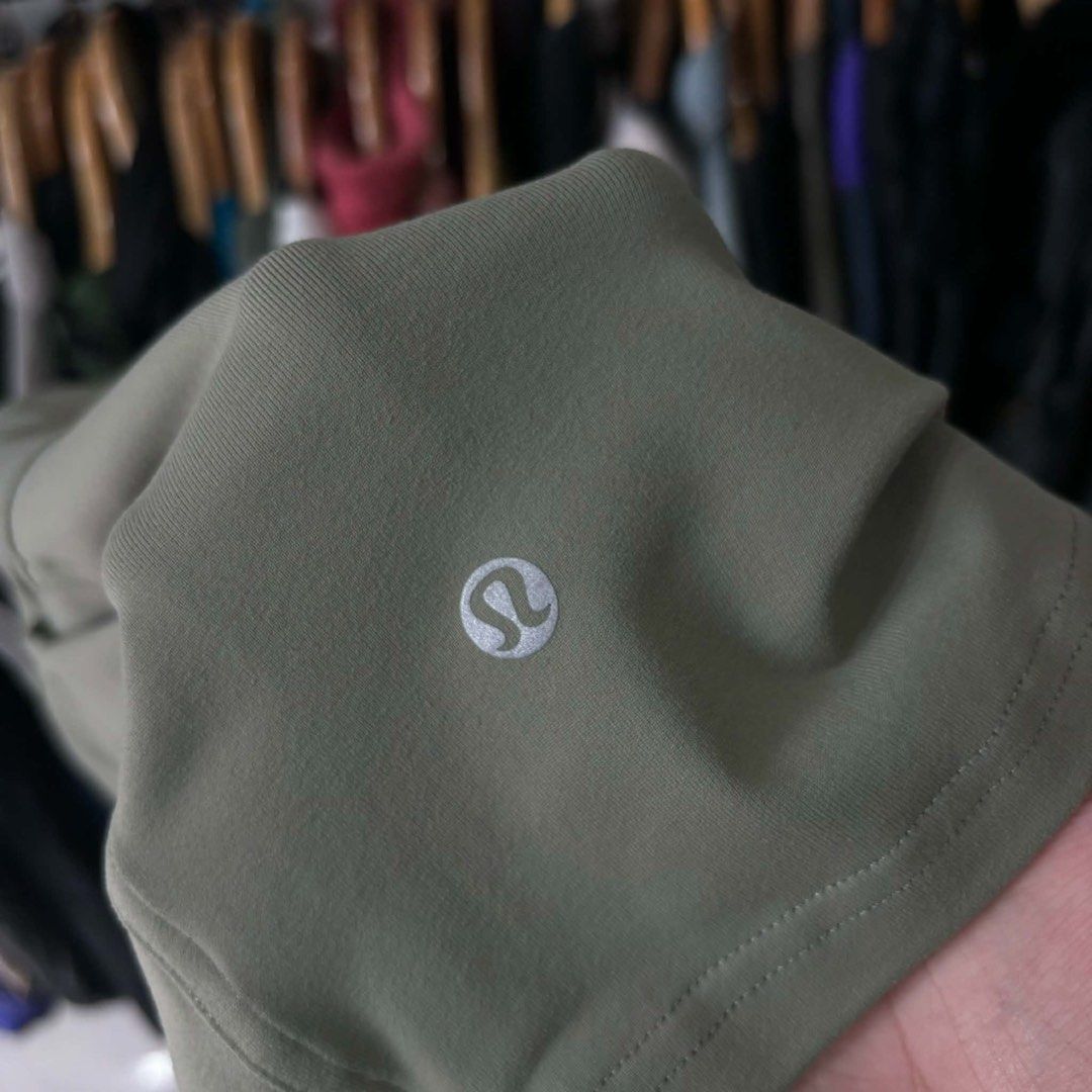 Lululemon Olive Green Athletic Shorts (Category: Shorts) located in Bambang. Submitted by heats777 (Listing ID 1471010953, Image 3). Description: - Brand: Lululemon - Color: Olive green - Fabric: Smooth, stretchy, high-performance material - Waistband: Elastic with adjustable drawstring closure - Features: Convenient front pockets and back yoke seam - Detail: Reflective logo heat-pressed on the back leg hem - Condition: Excellent, well-maintained