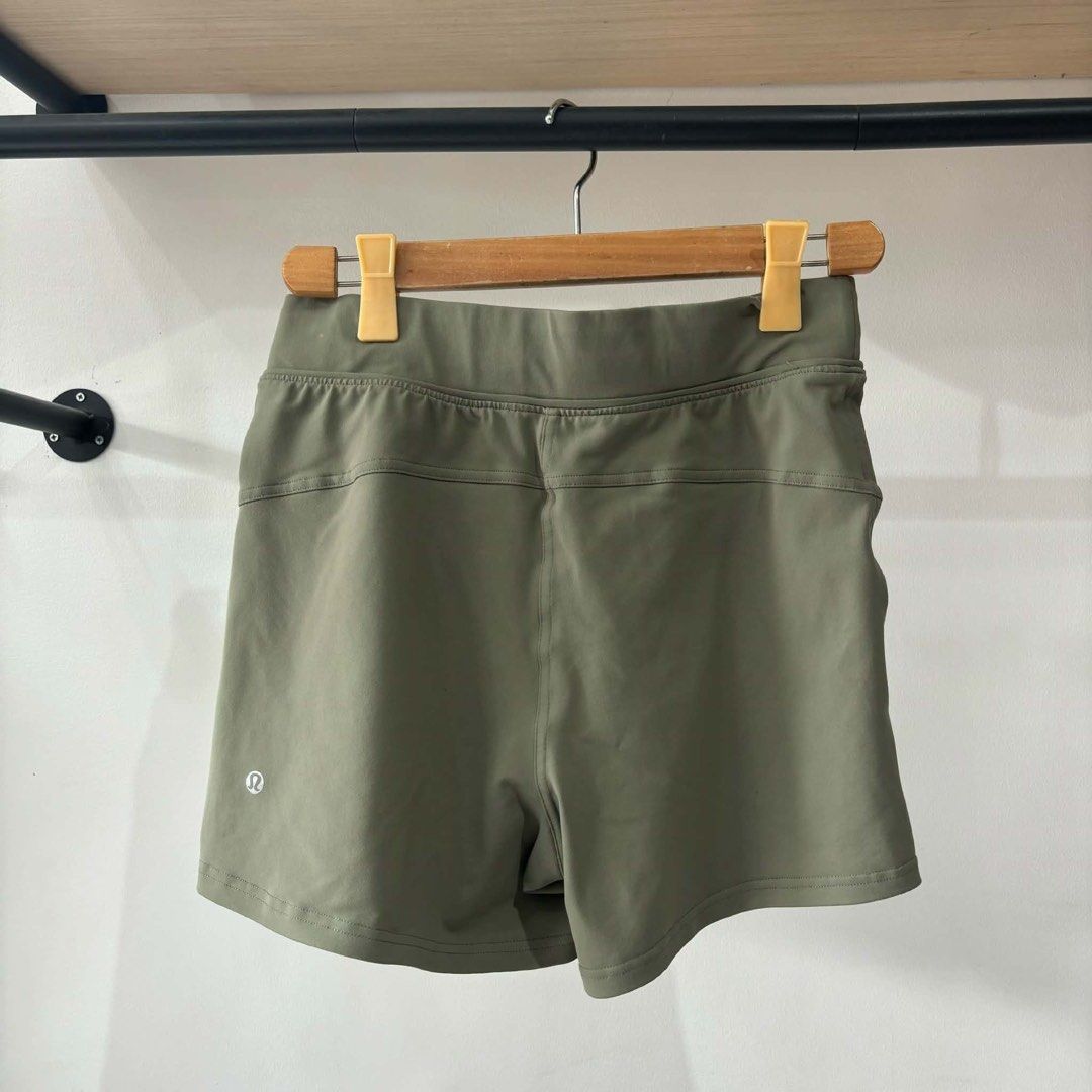 Lululemon Olive Green Athletic Shorts (Category: Shorts) located in Bambang. Submitted by heats777 (Listing ID 1471010953, Image 2). Description: - Brand: Lululemon - Color: Olive green - Fabric: Smooth, stretchy, high-performance material - Waistband: Elastic with adjustable drawstring closure - Features: Convenient front pockets and back yoke seam - Detail: Reflective logo heat-pressed on the back leg hem - Condition: Excellent, well-maintained