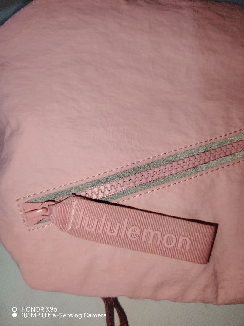 Lululemon Pink Crossbody Bag (Category: Cross-body Bags) located in Manila. Submitted by solenjella65945 (Listing ID 1471113258, Image 2). Description: - Authentic Lululemon shoulder bag in a cute pink shade - Clean condition with no major flaws - Stylish front diagonal zipper pocket - Matching pink strap with adjustable silver hardware buckle - Pink interior lining featuring a mesh slip pocket and Lululemon logo patch.