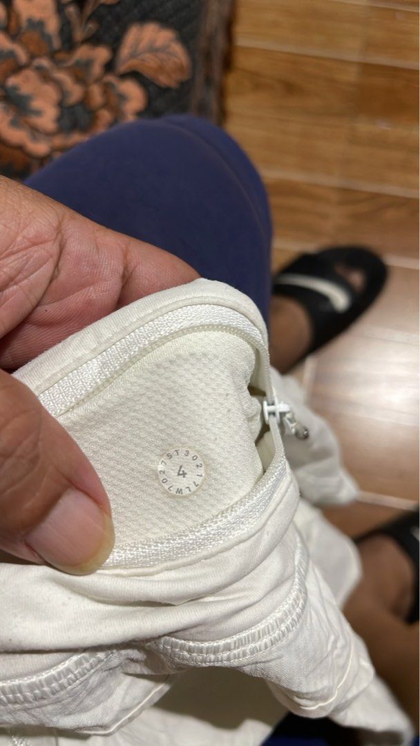 Lululemon White Athletic Shorts Size 4 (Category: Shorts) located in Mandaluyong City. Submitted by mark2pac (Listing ID 1471060060, Image 2). Description: - Brand: Lululemon - Color: Classic White - Size: 4 (verified by size dot inside pocket) - Design: Flattering crossover waistband with built-in lining - Features: Secure zippered pocket for small essentials.