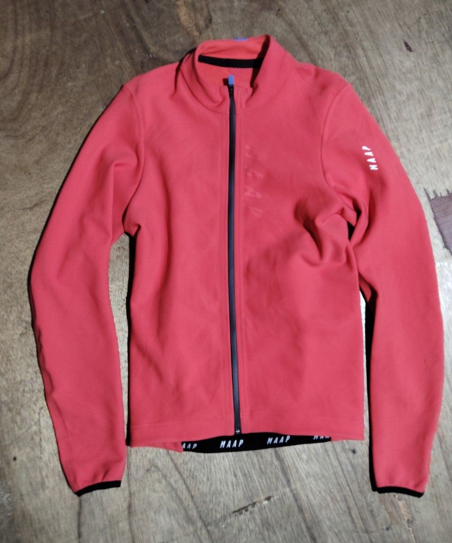 MAAP Red Cycling Jacket Thermal Long Sleeve (Category: Coats, Jackets and Outerwear) located in Mandaue City. Submitted by rodanthon (Listing ID 1471046982, Image 1). Description: - MAAP cycling jacket in bright red - Thermal textured inner lining keeps you warm on cold rides - Full zip closure with stylish blue branded pull tab and reliable YKK hardware - Subtle tonal MAAP logo on chest and sleeve for a sleek look - Elastic hem ensures a secure,