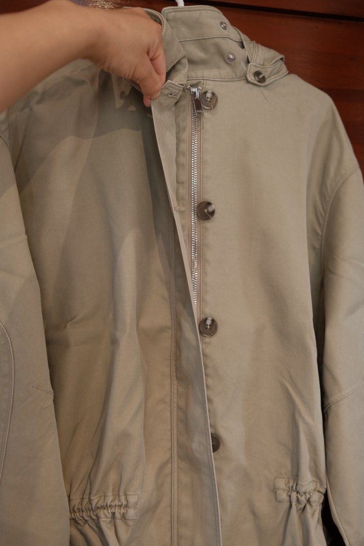 Mango Beige Hooded Jacket With Ruffled Hem (Category: Coats, Jackets and Outerwear) located in Makati City. Submitted by nomoreclutterph (Listing ID 1471048184, Image 3). Description: - Color: Versatile beige / neutral earth tone - Closure: Full front zipper with a button placket - Collar & Hood: High neckline with button closure and a removable hood (snap-on) - Fit & Style: Long sleeves with wide cuffs and a stylish ruffled hem with an adjustabl
