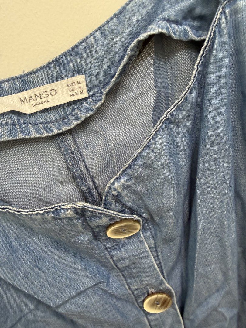 Mango Denim Midi Dress Size S/M (Category: Dresses) located in Quezon City. Submitted by reivia.vend (Listing ID 1471018357, Image 2). Description: - Brand: Mango - Size: EUR M / USA S / MEX M - Color: Mid blue wash - Style: Sleeveless, square neckline, front button placket with tortoiseshell buttons - Details: Includes matching self-tie fabric belt and two large front patch pockets - Material: Lightweight denim - Condition: Great casual piece fo