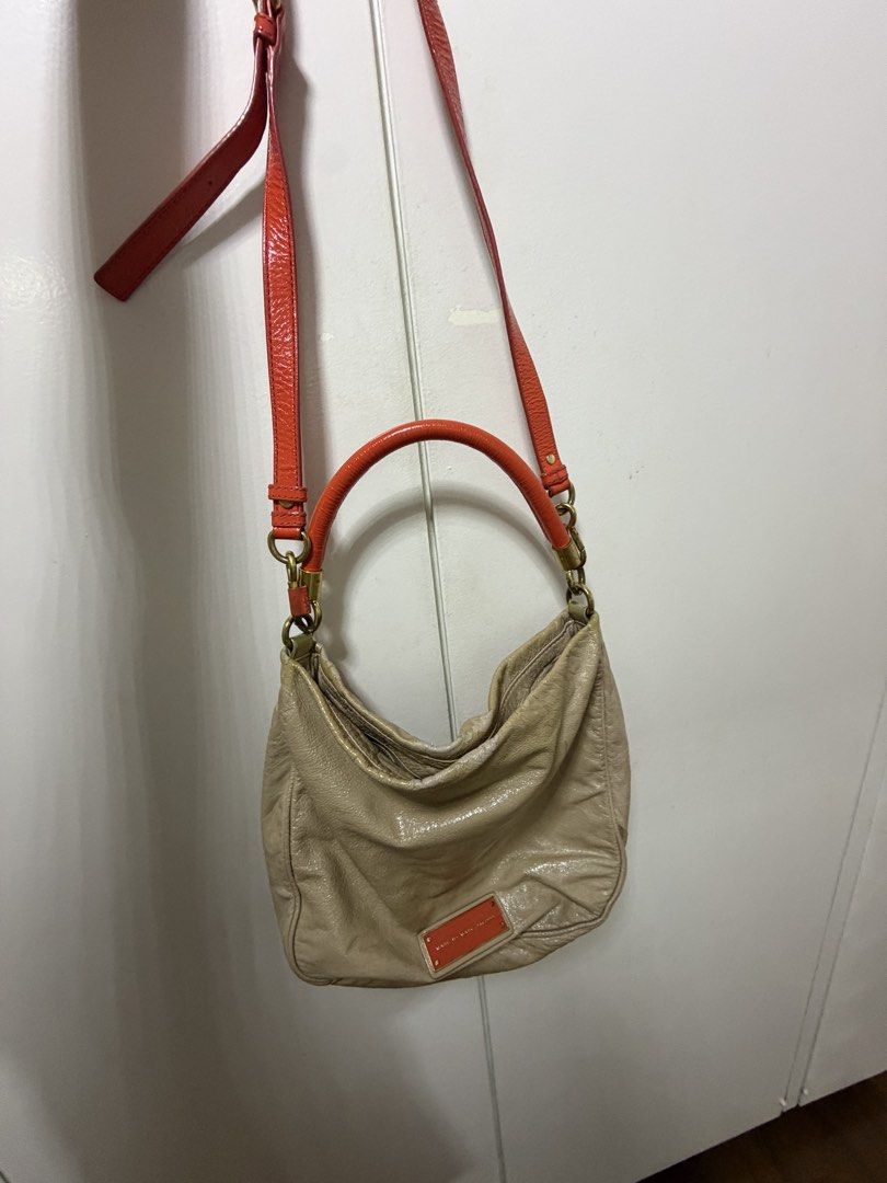 Marc by Marc Jacobs Beige Orange Leather Shoulder Bag (Category: Luxury Bags & Wallets) located in Makati City. Submitted by genuinelygoods (Listing ID 1470936553, Image 1). Description: - Brand: Marc Jacobs - Material: orange & Beige patent leather with fabric monogram interior lining - Colorway: Beige with vibrant orange handle, matching orange front logo plaque, and brass-tone hardware - Straps: Top handle and a convenient detachable crossbody