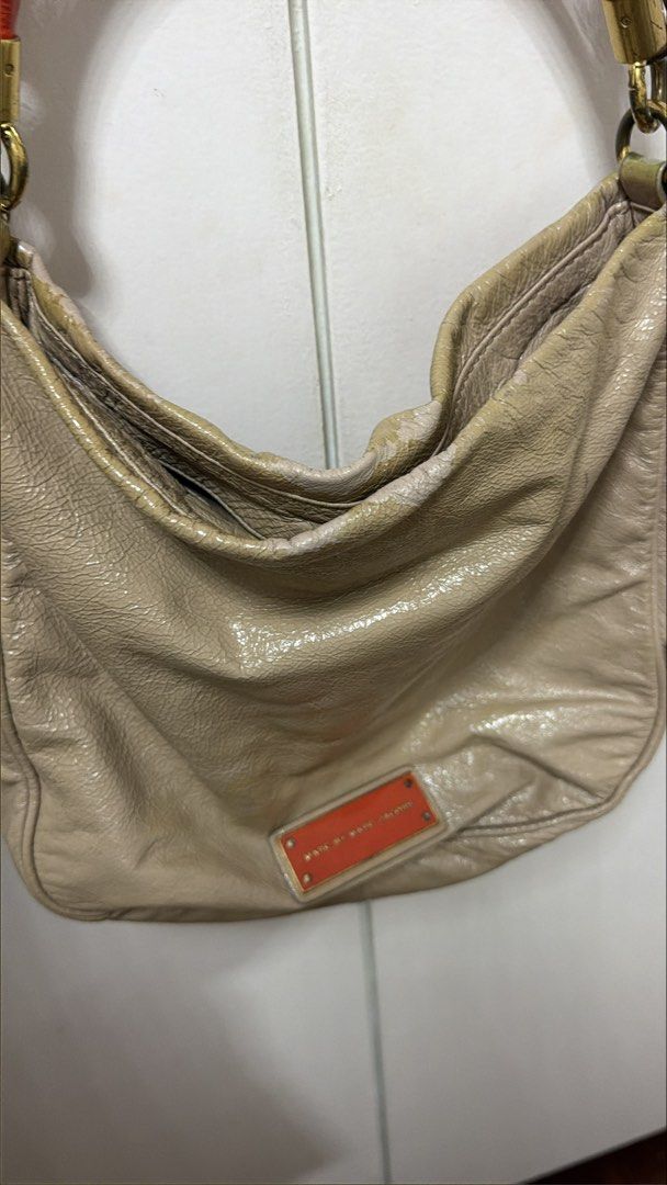 Marc by Marc Jacobs Beige Orange Leather Shoulder Bag (Category: Luxury Bags & Wallets) located in Makati City. Submitted by genuinelygoods (Listing ID 1470936553, Image 2). Description: - Brand: Marc Jacobs - Material: orange & Beige patent leather with fabric monogram interior lining - Colorway: Beige with vibrant orange handle, matching orange front logo plaque, and brass-tone hardware - Straps: Top handle and a convenient detachable crossbody