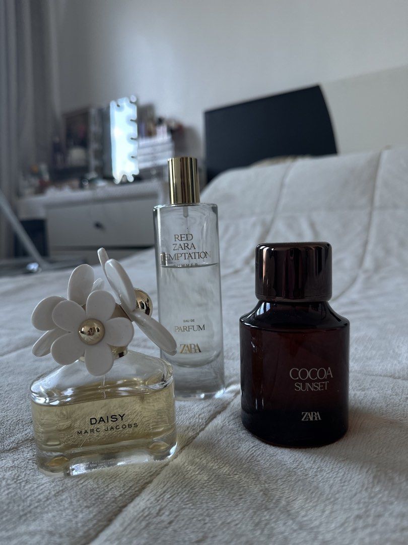 Marc Jacobs Daisy and Zara Perfume Red Tempt (Category: Fragrance & Deodorants) located in Bacoor. Submitted by missleahloy (Listing ID 1471038281, Image 1). Description: - Bundle includes 2 fragrance bottles: Marc Jacobs Daisy, Zara Temptation Summer - Marc Jacobs Daisy features yellow liquid with signature flower cap - Zara Temptation Summer comes in clear glass with a gold cap - Condition: About half full to mostly full - Great value way to co