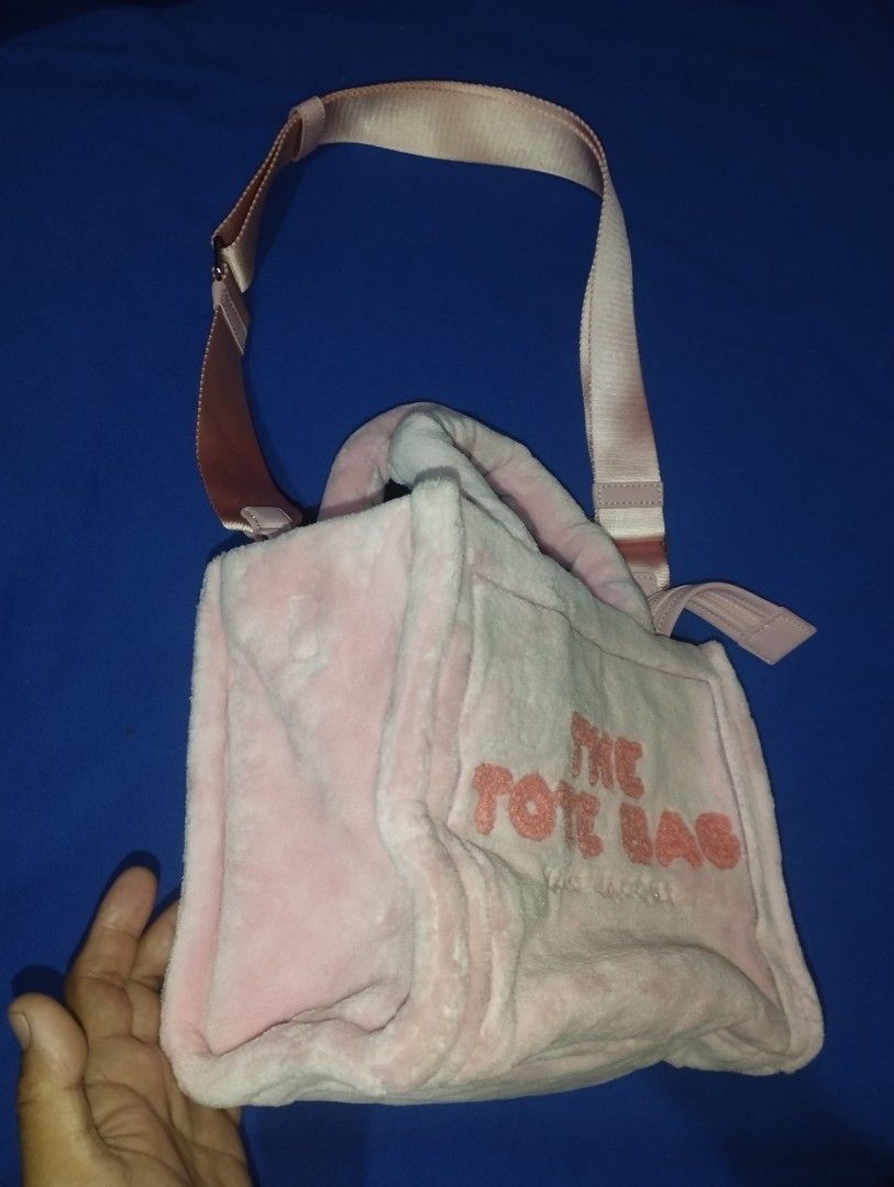 Marc Jacobs The Terry Small Tote Bag Pink (Category: Luxury Bags & Wallets) located in Muntinlupa City. Submitted by beckster_online_luxuryshop (Listing ID 1471076472, Image 2). Description: - Style: Marc Jacobs Tote Bag - Material: Soft pink fluffy fabric with bold orange lettering NEGO - Handles: Double top handles and an adjustable, removable shoulder strap - Closure: Secure top zipper for the spacious main compartment - Interior: Includes off