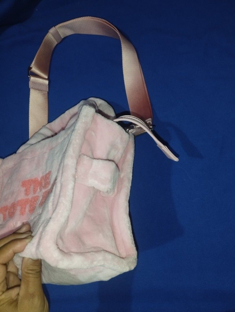 Marc Jacobs The Terry Small Tote Bag Pink (Category: Luxury Bags & Wallets) located in Muntinlupa City. Submitted by beckster_online_luxuryshop (Listing ID 1471076472, Image 3). Description: - Style: Marc Jacobs Tote Bag - Material: Soft pink fluffy fabric with bold orange lettering NEGO - Handles: Double top handles and an adjustable, removable shoulder strap - Closure: Secure top zipper for the spacious main compartment - Interior: Includes off