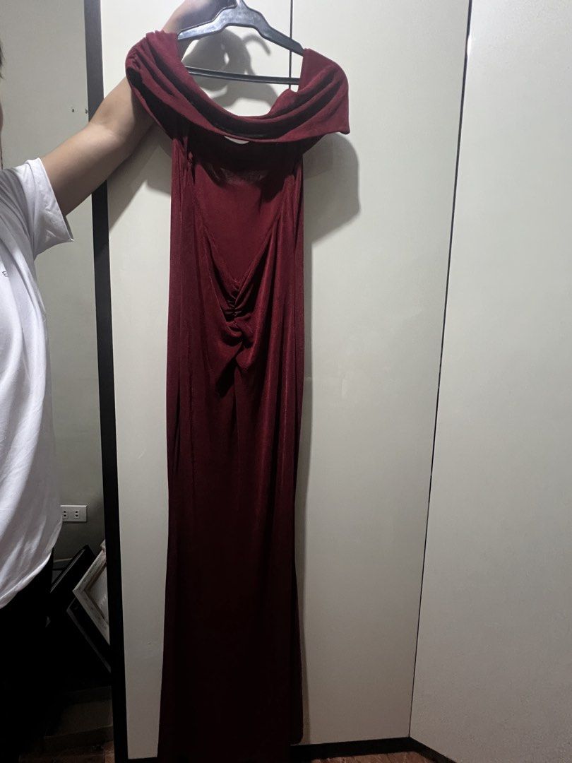 Maroon Off-Shoulder Long Evening Dress (Category: Evening dresses & gowns) located in Muntinlupa City. Submitted by saiki__ (Listing ID 1470934260, Image 3). Description: - Color: Deep maroon - Style: Off-shoulder with draped collar and floor-length silhouette - Fabric: Velvet-like textured material - Details: Ruched gathered detail at the lower back - Occasion: Perfect for formal events, dinners, or parties - Condition: Clean, excellent, and rea