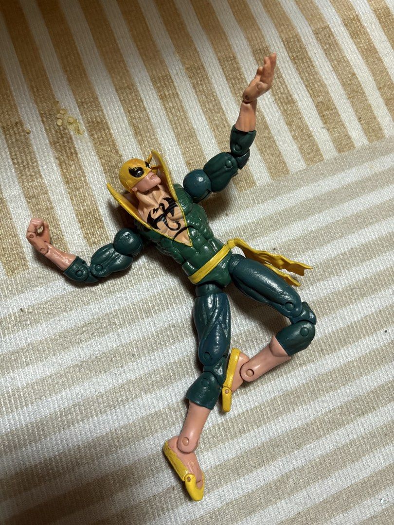 Marvel Legends Iron Fist Action Figure (Category: Figurines & Statues) located in Manila. Submitted by khoon01e (Listing ID 1470986798, Image 3). Description: - Green and yellow classic Marvel Iron Fist action figure - Features iconic dragon logo on chest and tall collar - Highly articulated limbs for dynamic martial arts and fighting poses - Stands firmly for easy display - Great collectible piece for comic fans and Defenders fans.
