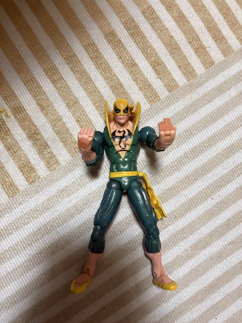 Marvel Legends Iron Fist Action Figure (Category: Figurines & Statues) located in Manila. Submitted by khoon01e (Listing ID 1470986798, Image 1). Description: - Green and yellow classic Marvel Iron Fist action figure - Features iconic dragon logo on chest and tall collar - Highly articulated limbs for dynamic martial arts and fighting poses - Stands firmly for easy display - Great collectible piece for comic fans and Defenders fans.