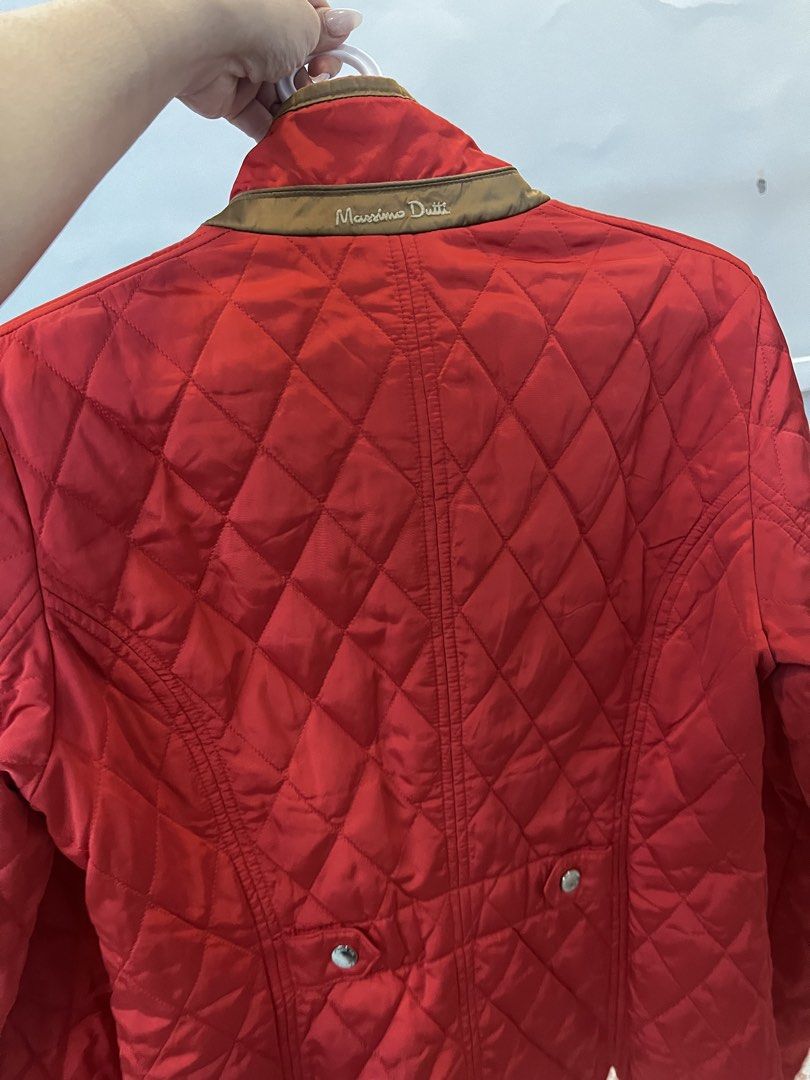 Massimo Dutti Red Quilted Jacket Size L (Category: Coats, Jackets and Outerwear) located in Calamba. Submitted by noreenmend83749 (Listing ID 1470962220, Image 2). Description: - Brand: Massimo Dutti - Color: Bright Red with Brown Trim - Size: EUR L / USA L / MEX 34 - Details: Gold brand lettering on the back, front snap buttons, lower patch pockets with snap closures - Lining: Stylish striped inner lining - Origin: Made in Vietnam Preloved :) no