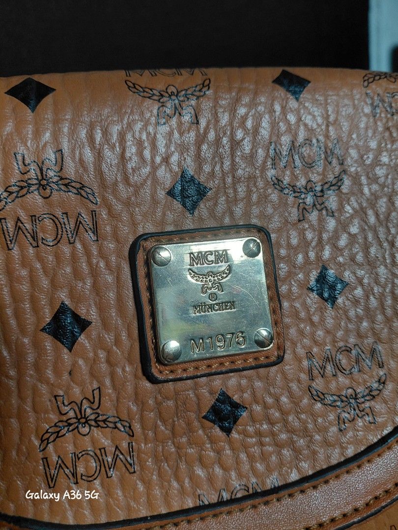 MCM Cognac Visetos Monogram Crossbody Bag (Category: Luxury Bags & Wallets) located in Baguio. Submitted by tabuzomaria1422 (Listing ID 1470978564, Image 3). Description: - Brand: MCM - Color: Classic cognac brown with all-over monogram print - Hardware: Premium gold-tone with front logo plaque - Interior: Fabric-lined with 1 zip pocket and slip compartments - Closure: Secure snap button on front flap - Condition: Excellent / Well-maintained - Mo