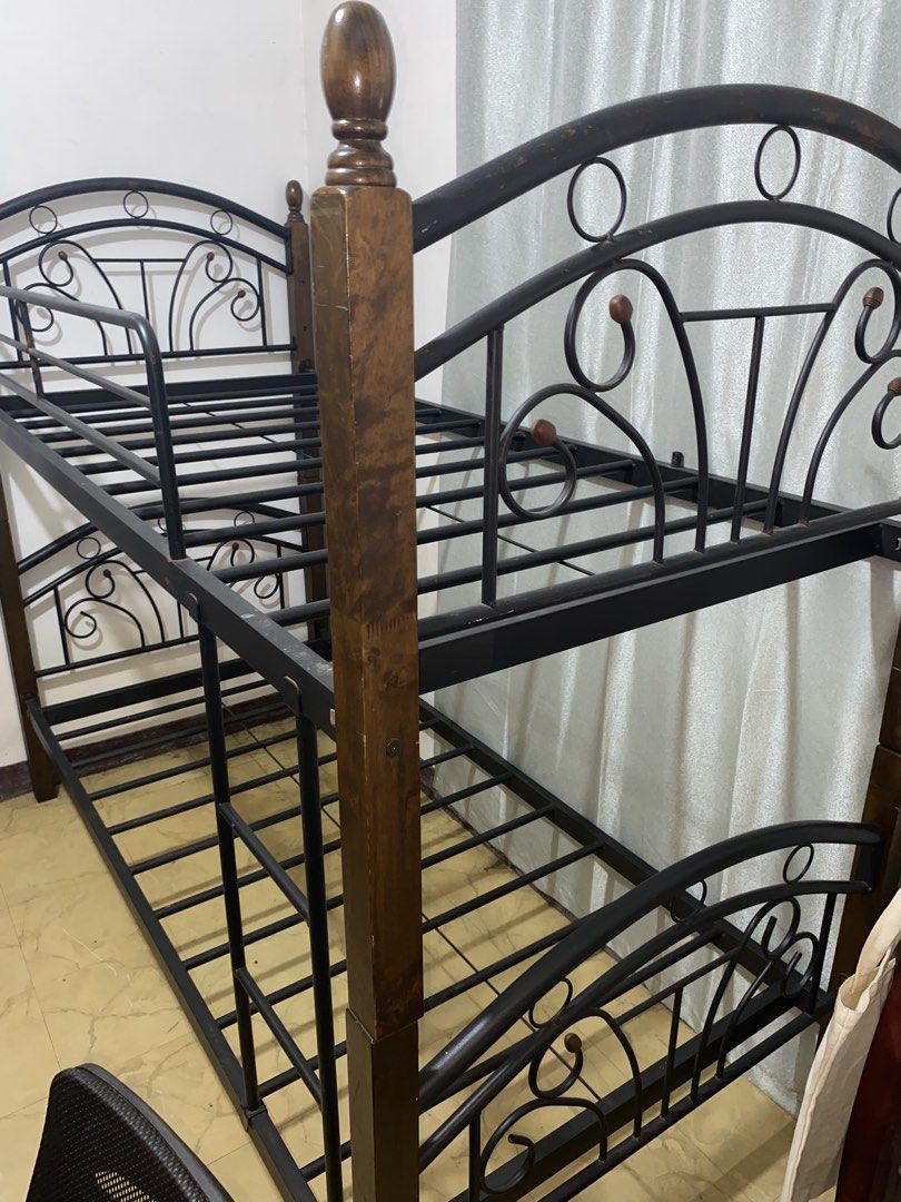 Metal and Wood Bunk Bed (Category: Bed Frames & Mattresses) located in Manila. Submitted by ynzainn (Listing ID 1471064218, Image 1). Description: Price is slightly negotiable. - Made from alloy metal and solid wood - Has minor surface rust - Wood is in good condition - Has few small missing parts but does not affect the stability of the frame - Comes with 2 guard railings for the top bunk and a ladder.