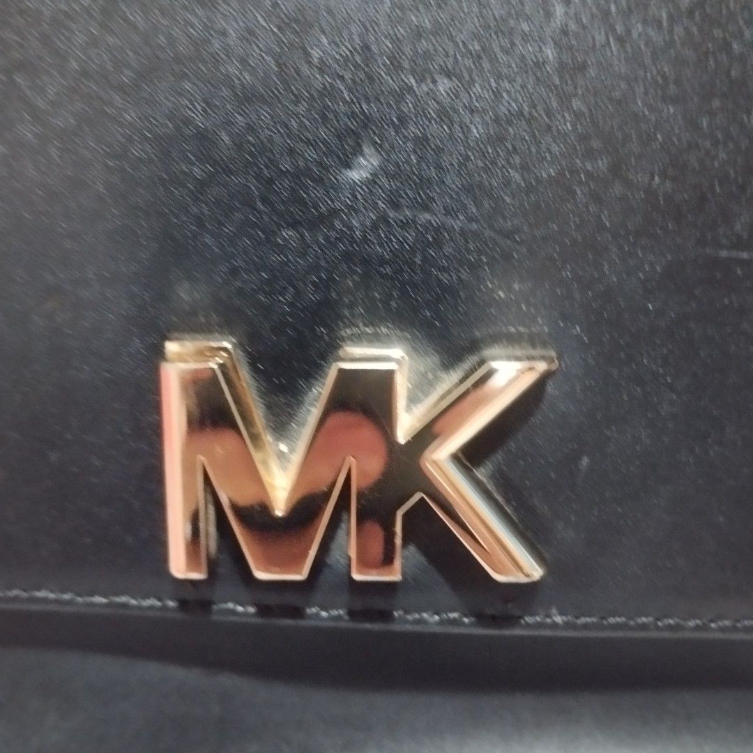 Michael Kors Black Leather Handbag with Gold Chain (Category: Cross-body Bags) located in Manila. Submitted by lene48 (Listing ID 1471051065, Image 3). Description: - Brand: Michael Kors - Color: Classic Black with luxurious Gold hardware - Material: Premium Leather - Design: Structured crossbody with prominent front MK logo and a convenient top handle - Strap: Unique combination of a chunky gold chain and comfortable leather shoulder sections - 