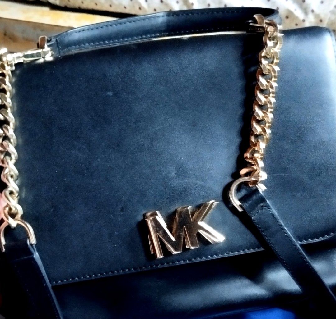 Michael Kors Black Leather Handbag with Gold Chain (Category: Cross-body Bags) located in Manila. Submitted by lene48 (Listing ID 1471051065, Image 1). Description: - Brand: Michael Kors - Color: Classic Black with luxurious Gold hardware - Material: Premium Leather - Design: Structured crossbody with prominent front MK logo and a convenient top handle - Strap: Unique combination of a chunky gold chain and comfortable leather shoulder sections - 