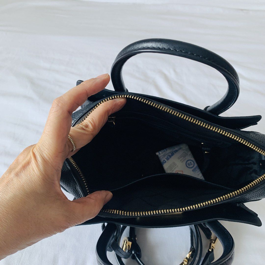 Michael Kors Mercer Satchel Brown Black (Category: Luxury Bags & Wallets) located in Makati City. Submitted by aliahs_personal_item (Listing ID 1470977203, Image 2). Description: - Brand: Michael Kors Mercer Satchel - Color/Material: Brown monogram print with black leather trim - Hardware: Elegant gold-tone - Dimensions: Approx. 28 cm (W) x 20 cm (H) - Compartments: Dual grab handles, top zip closure, central zip compartment, and interior slip po