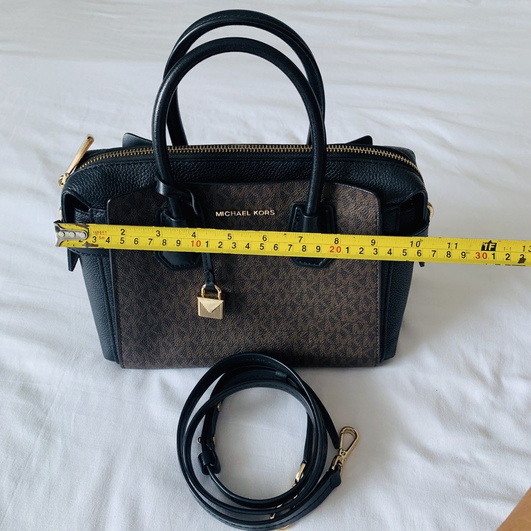 Michael Kors Mercer Satchel Brown Black (Category: Luxury Bags & Wallets) located in Makati City. Submitted by aliahs_personal_item (Listing ID 1470977203, Image 3). Description: - Brand: Michael Kors Mercer Satchel - Color/Material: Brown monogram print with black leather trim - Hardware: Elegant gold-tone - Dimensions: Approx. 28 cm (W) x 20 cm (H) - Compartments: Dual grab handles, top zip closure, central zip compartment, and interior slip po