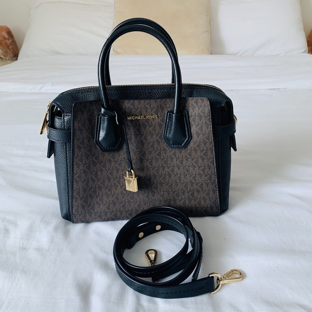 Michael Kors Mercer Satchel Brown Black (Category: Luxury Bags & Wallets) located in Makati City. Submitted by aliahs_personal_item (Listing ID 1470977203, Image 1). Description: - Brand: Michael Kors Mercer Satchel - Color/Material: Brown monogram print with black leather trim - Hardware: Elegant gold-tone - Dimensions: Approx. 28 cm (W) x 20 cm (H) - Compartments: Dual grab handles, top zip closure, central zip compartment, and interior slip po