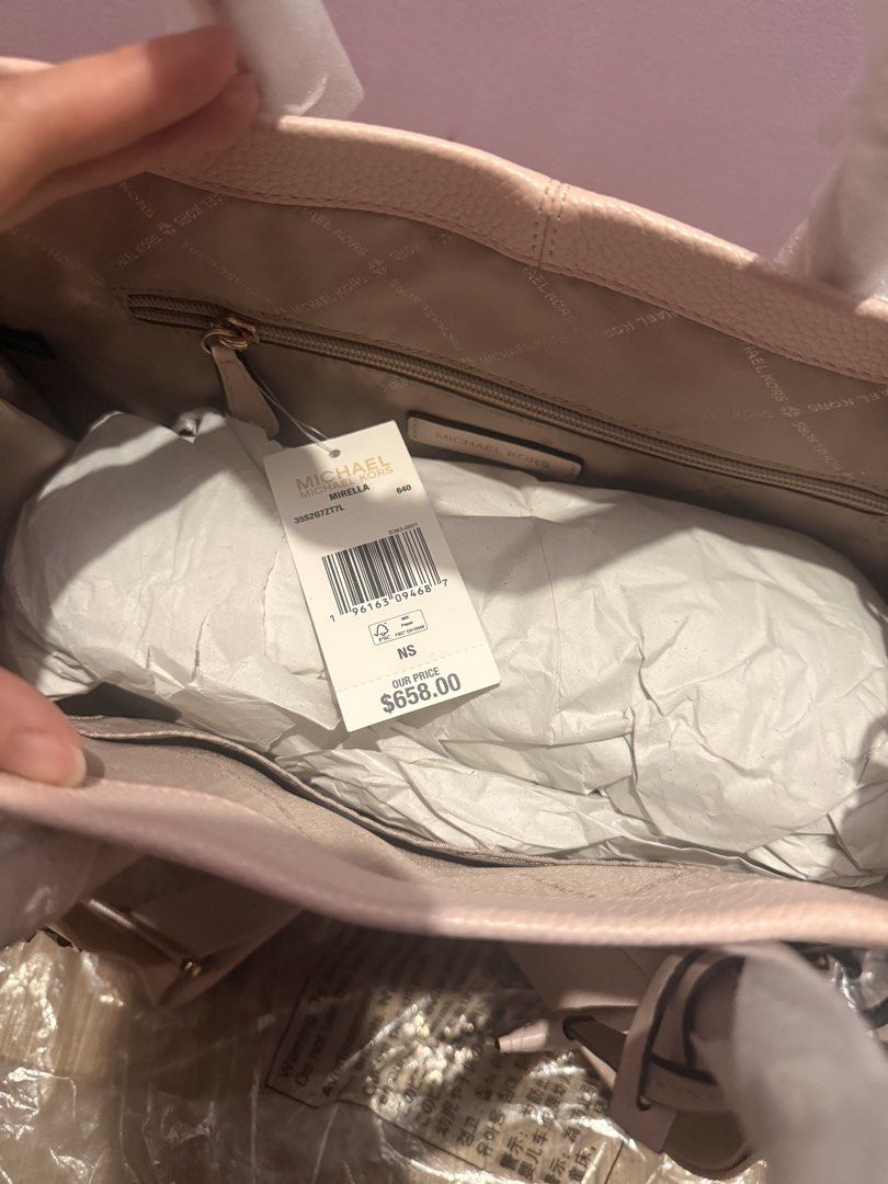 Michael Kors Mirella Pink Tote Bag (Category: Shoulder Bags) located in Pasig City. Submitted by sea321 (Listing ID 1470940293, Image 3). Description: - Authentic Michael Kors Mirella tote in Powder Blush Multi - Crafted from durable pebbled leather with elegant gold-tone hardware - Dual top handles and a convenient adjustable fabric shoulder strap - Spacious fabric-lined interior featuring a secure zip pocket and slip pockets - Includes matching