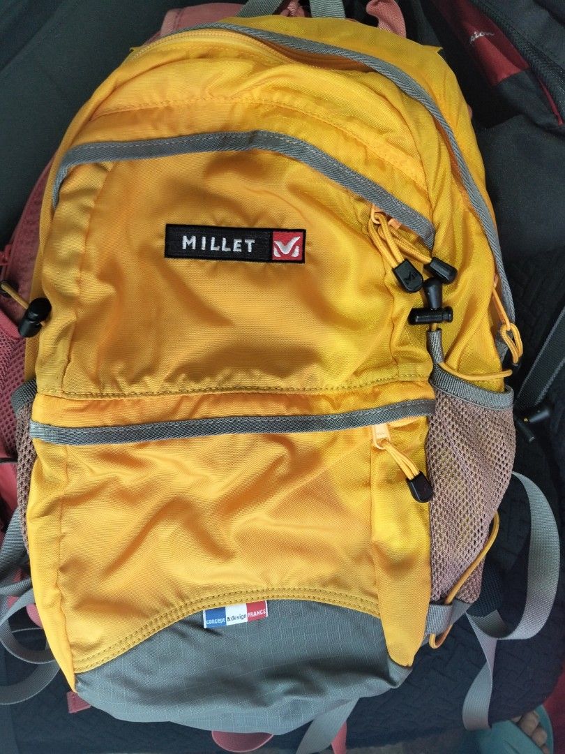 Millet Yellow Hiking Backpack (Category: Hiking & Camping) located in Abucay. Submitted by cristineca20489 (Listing ID 1470955581, Image 1). Description: - Brand: Millet - Color: Bright yellow with stylish grey accents - Storage: Front zippered pocket, main compartment, and internal zip mesh pocket - Convenience: Dual mesh side pockets for water bottles or essentials - Comfort: Padded mesh back panel and fully adjustable shoulder straps - Perfect