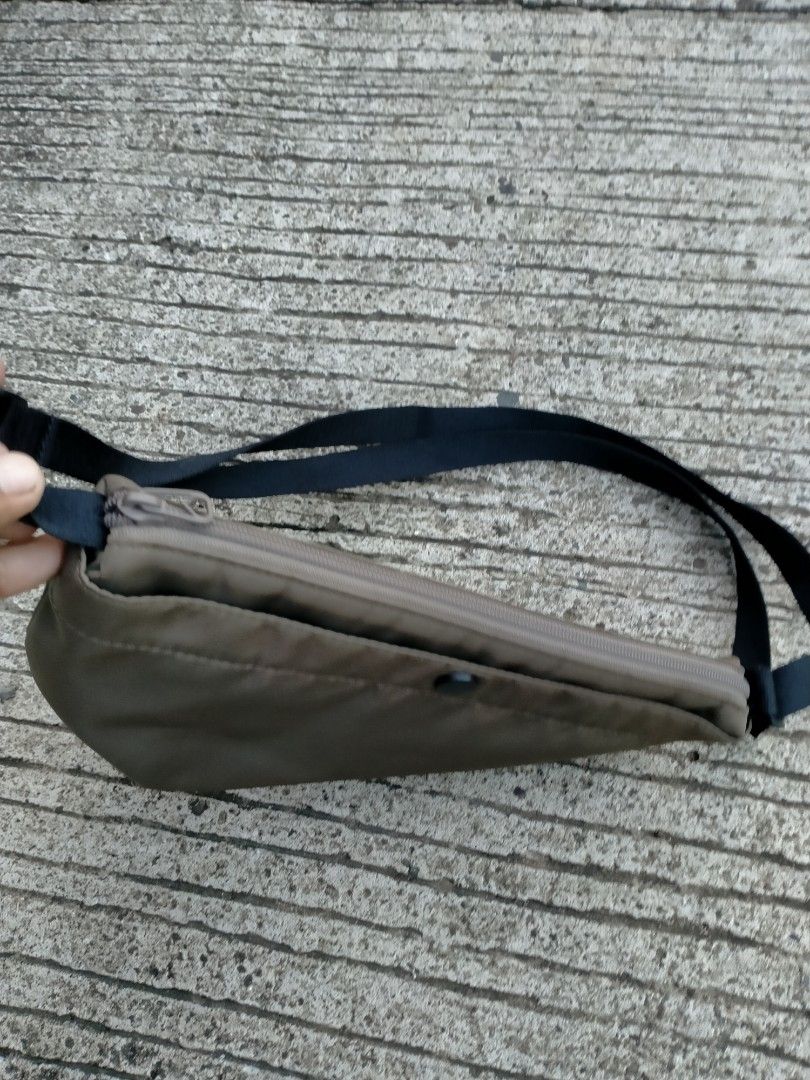 Minimalist Crossbody Bag with Adjustable Black Strap (Category: Cross-body Bags) located in Davao. Submitted by ervinpolino09 (Listing ID 1471013063, Image 2). Description: Uniqlo Nylon Sling Bag - Material: Smooth, durable nylon - Strap: Adjustable black strap - Closure: Secure top zip - Pockets: Small front pocket with dark snap button - Design: Curved structured bottom with clean stitching - Style: Simple and versatile everyday carryall.