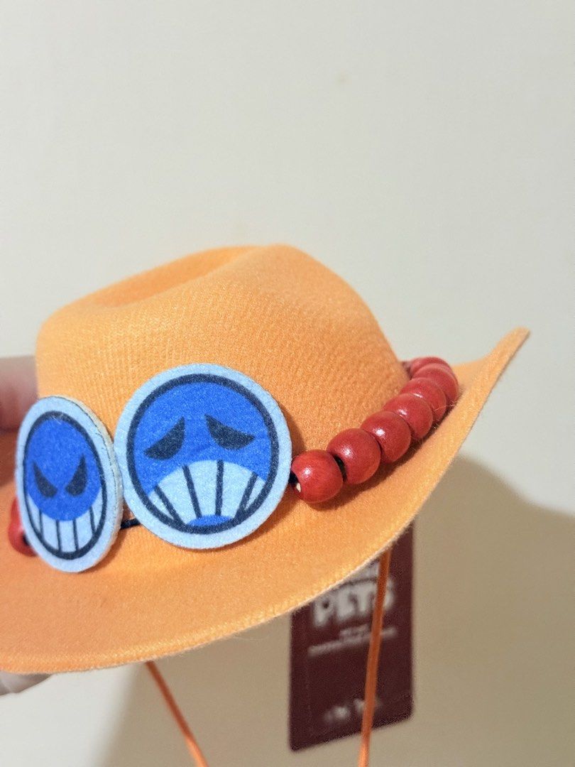 Miniso Pets One Piece Pet Hat (Category: Homes & Other Pet Accessories) located in Mandaluyong City. Submitted by rocagarces (Listing ID 1471081056, Image 2). Description: - Official Miniso x One Piece collaboration pet hat - Vibrant orange color with cute character face details - Secure fit with an adjustable chin cord and stylish bead strap - Brand new with original tags still attached - Perfect for pet photoshoots and anime-loving pawrents.