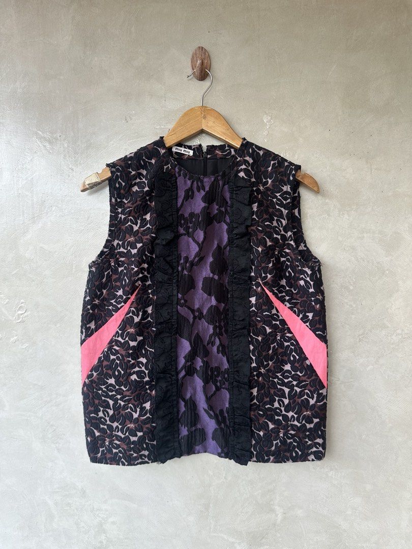 MIU MIU - Multicolour Jacquard Sleeveless Top (Category: Luxury Apparel) located in Cavite. Submitted by second_story_ph (Listing ID 1471066072, Image 1). Description: MIU MIU - Multicolour Jacquard Sleeveless Top A Miu Miu sleeveless jacquard top featuring a purple and black floral pattern, black ruffled front trim, and bright pink side accents. Size: 40 Dimension: 18” Width / 24” Length / 14.5” Shoulder Condition: Like New.