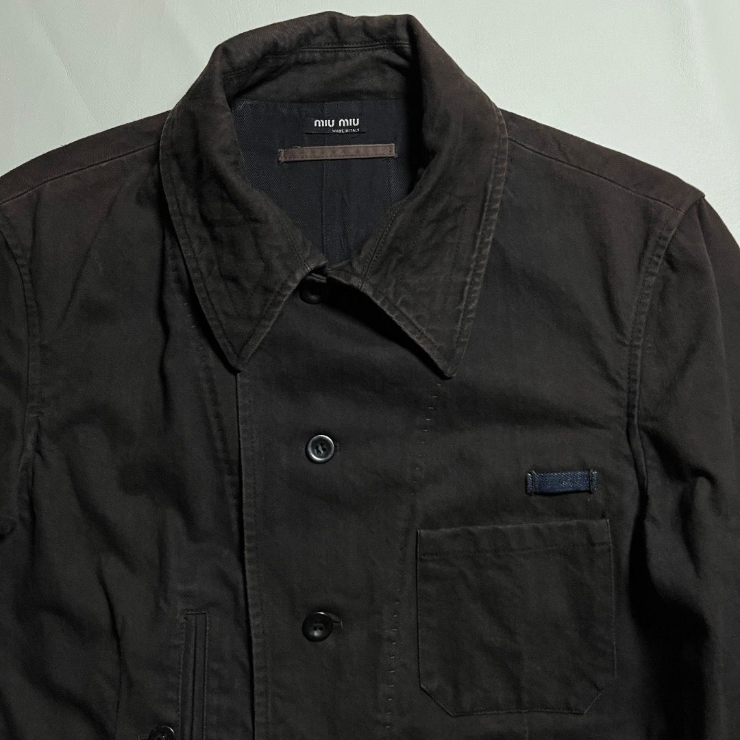 Miu Miu Archive Denim Dark Brown Jacket (Category: Coats, Jackets and Outerwear) located in Caloocan City. Submitted by achilles_grails (Listing ID 1471048158, Image 3). Description: - Brand: Authentic Miu Miu (Made in Italy) - Material: Premium deep brown cotton twill - Design: Contrast topstitching, front button closure, single chest pocket - Fit: Adjustable side tabs at the back waist - Condition: Clean construction, true archive piece.