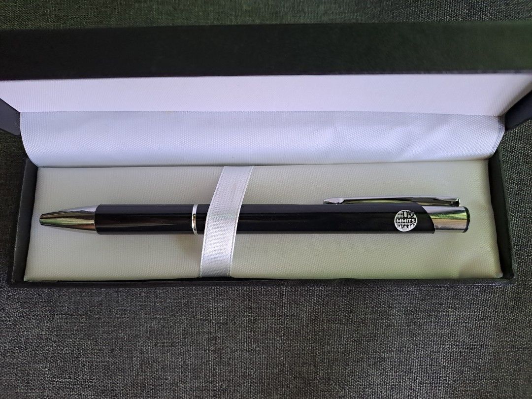 Promotional Pen in Gift Box (Category: Stationery & School Supplies) located in Quezon City. Submitted by ph_araoh (Listing ID 1470991657, Image 2). Description: - Item: Brand new black click pen with MMITS logo - Sleek black body with stylish silver-tone clip and tip - Packaging: Includes black box - Condition: 100% unused and clean - Ideal For: Gifting, office use, or memorabilia collection Courier delivery available P95 shipping within Metro M