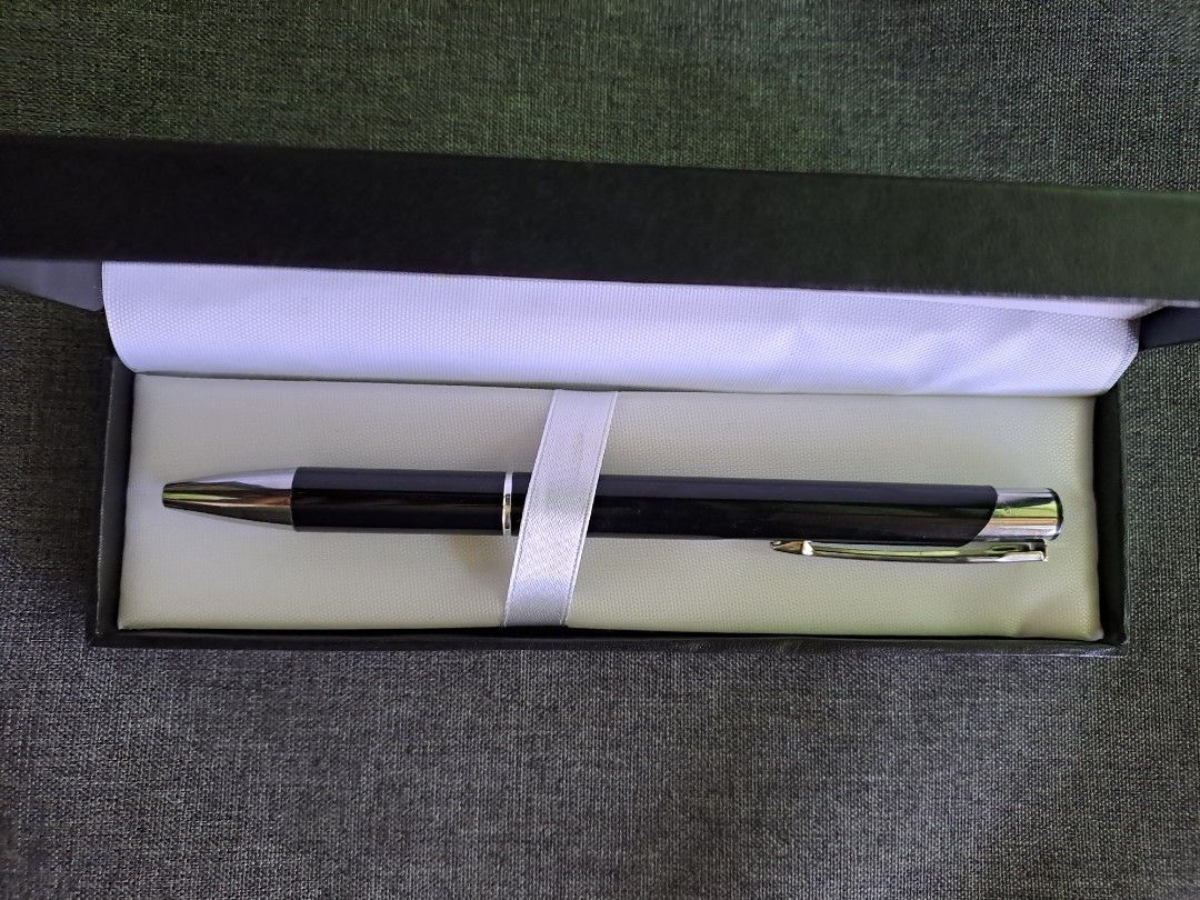 Promotional Pen in Gift Box (Category: Stationery & School Supplies) located in Quezon City. Submitted by ph_araoh (Listing ID 1470991657, Image 1). Description: - Item: Brand new black click pen with MMITS logo - Sleek black body with stylish silver-tone clip and tip - Packaging: Includes black box - Condition: 100% unused and clean - Ideal For: Gifting, office use, or memorabilia collection Courier delivery available P95 shipping within Metro M
