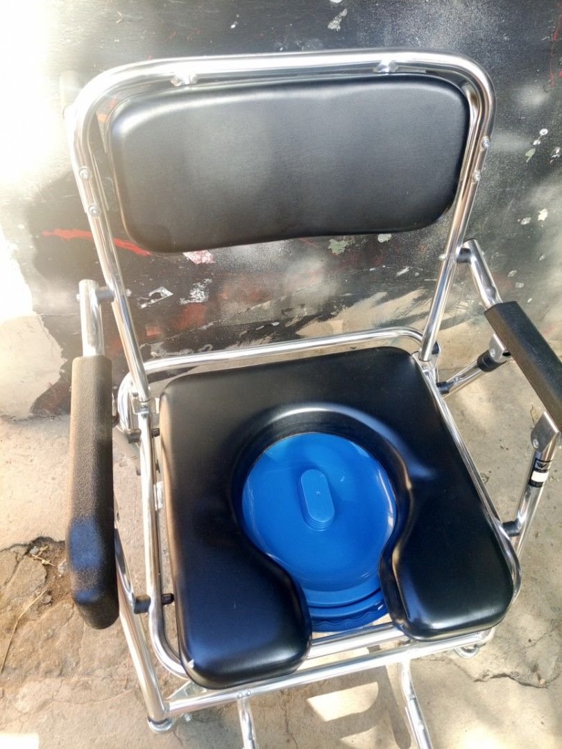 Mobile Commode Chair with Wheels and Removable Bucket (Category: Medical Supplies & Tools) located in Manila. Submitted by warmcrystal_269010 (Listing ID 1470993457, Image 3). Description: - Material: Durable stainless steel frame - Comfort: Black padded seat, backrest, and armrests - Convenience: Includes blue removable commode bucket with lid - Mobility: 4 smooth-rolling wheels for easy movement around the house - Support: Built-in footrest for